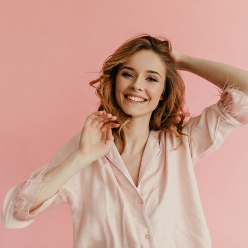 Wonderful,Happy,Lady,With,Curly,Hair,In,Stylish,Pink,Slumber-suit