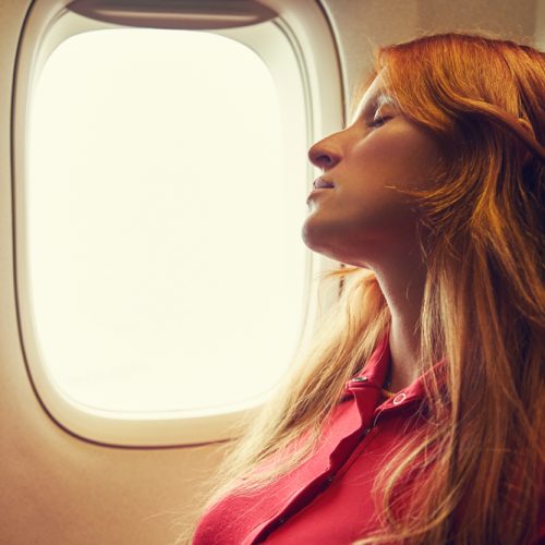 Sleeping,Woman,In,The,Chair,On,Board,An,Airplane