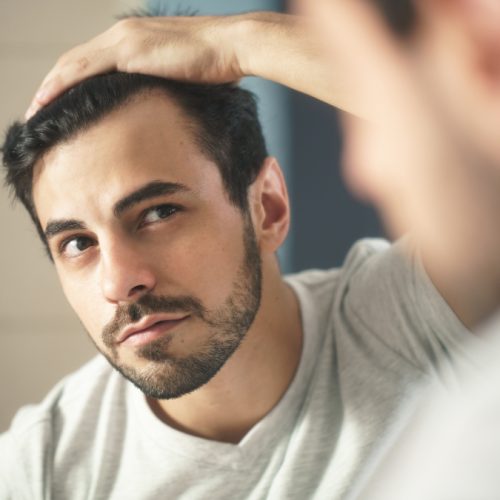 Latino,Person,With,Beard,Grooming,In,Bathroom,At,Home.,White